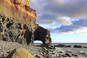 Lonely beach with a natural stone arch on the Atlantic Ocean in the Canary Islands