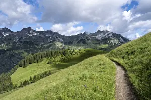 Lonely hiking trail, mountains behind