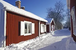Long row of red wooden houses, winter