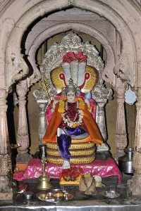 Lord Vishnu resting on sheshnag in Hindu temple altar