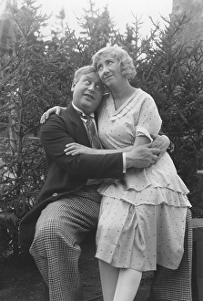 Love in the 1930s. A couple and where she sits on his lap and they are hugging each other tenderly