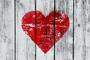 Love symbol on old wooden wall background