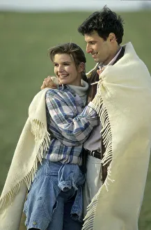 Lovers embrace and cuddle in a blanket