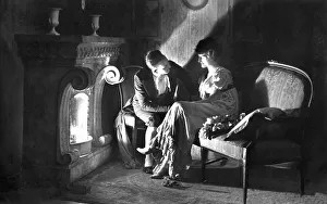 Lovers flirting in front of the fireplace