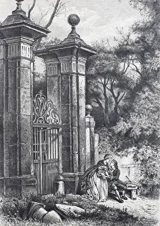 Lovers in front of the gate to a park