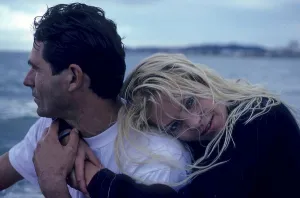 Lovers, woman embraces a man, leans her head on his shoulder
