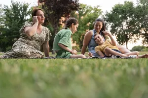 A loving family shares moments together in a grassy park