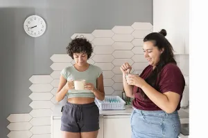A loving lesbian couple enjoys a morning coffee together in their modern kitchen