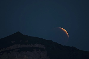 Lunar eclipse above the mountain station of Hohen Kasten