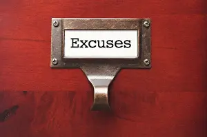 Lustrous wooden cabinet with excuses file label in dramatic light