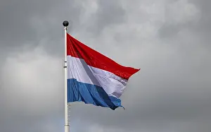 Luxembourg flag waving against a cloudy sky