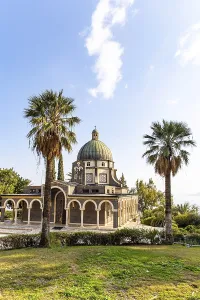 Magnificent monastery surrounded by columns and slender tall palms