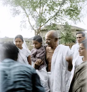 Mahatma Gandhi carrying a boy, Bharat, son of Madalasa Narayan at Satyagraha Ashram, Wardha, Maharashtra, India, Asia, 1945, Asia