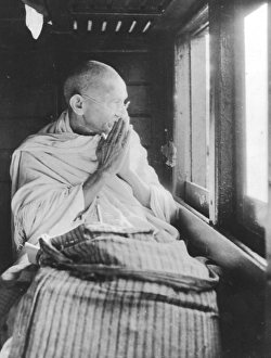 Mahatma Gandhi greeting people from train compartment