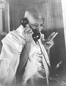 Mahatma Gandhi talking on telephone