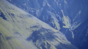 Majestic mountains with two griffon vultures (Gyps fulvus) in flight