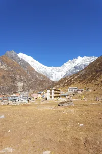 Majestic view of snow-capped Langtang Lirung Himalayan mountain range with Kyanjin Gompa village in foreground in Nepal