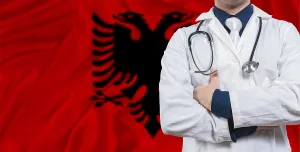 Male doctor with stethoscope on Albania flag