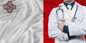 Male doctor with stethoscope on Malta flag