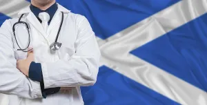 Male doctor with stethoscope on Scottish flag