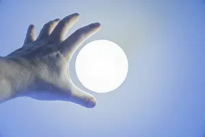 Male Hand Reaching a Illuminated Lamp on Ceiling in Switzerland