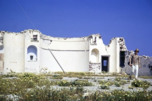 Male man tourist walking by old church ruin, Oia, Santorini, Cyclades islands, Greece, Europe, 1972, Europe