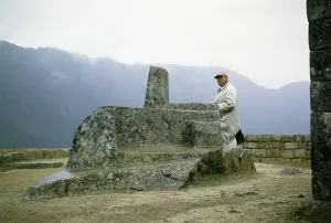 Male tourist at the Intihuatana sundial stone, Machu Picchu, Peru, South America, around 1962, South America