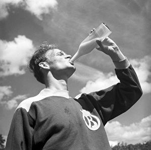 Man of the 1940s. Athlete Ake Spangert is cooling of after practise and drinks from a milkbottle in the sunshine