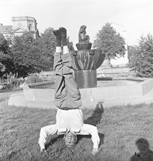 Man of the 1950s. A man is standing on his head balancing