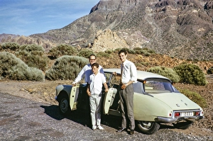 Man and two boys standing next to a Citreon car, Teide National Park, Tenerife, Canary Islands, Spain 1963
