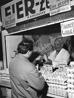 Man buys eggs at market stall, 1960s