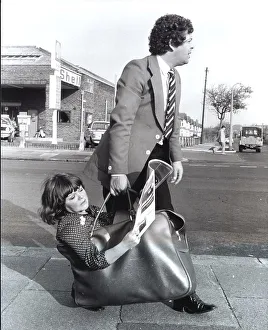 Man carries woman in bag, England, Great Britain