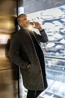 Man in an elegant coat making a phone call