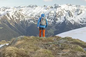 A man equipped with a backpack hikes through the stunning