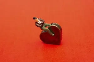Man figurine on a Heart shape as love conception