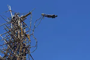 Framed Print : Man jumping from a bamboo tower Framed Print : Man jumping from a bamboo tower