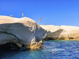 Man jumping from the cliff into the sea at Sarakiniko beach