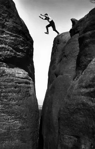 Man jumps over a crevice, historical photograph