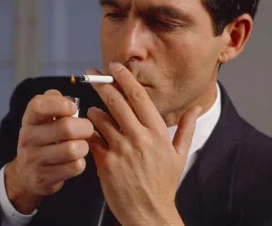 Man, light cigarettes and smoke