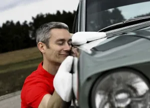 Man lovingly caring for his vintage car