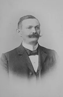 Man with moustache, suit and bow tie