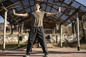 A man practices Yi Jin Jing, a Buddhist Chinese training method known as Changing Muscles and Tendons in Chi Kung