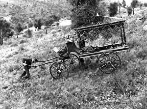 Man pushes a coffin carriage up the slope