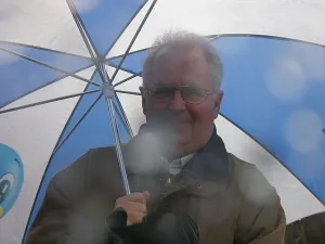 Man in the rain under an umbrella