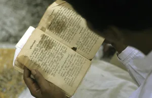 Man reading Buddhist writings, Burma