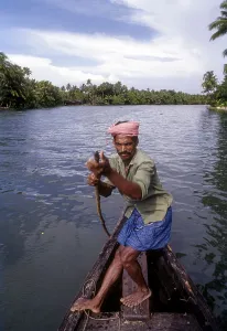 A man rowing, pushing the boat