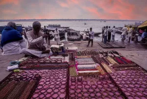 A man selling ornaments in front of Ganga Ganges River at Varanasi Benaras