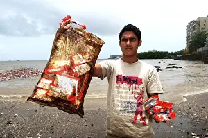 Category Historic EN Prints: Man showing oil soaked biscuit packets due to container ship chitra colliding in sea Bombay Mumbai