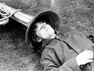 Man sleeps with his head in tuba, ca