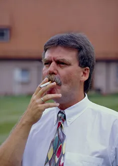 Man smokes cigarette outdoors